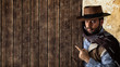 © Antonio Gravante - Gunfighter pointing on wooden table.