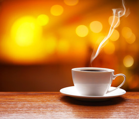 Poster - Cup of coffee on table on blured cafe background