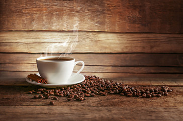 Canvas Print - Cup of coffee with grains on wooden background