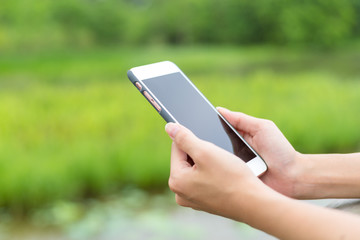 Poster - Woman hold with cellphone over green background