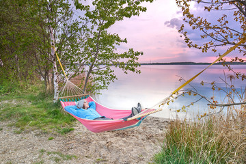 Canvas Print - Strandurlaub am See, Frau erholt sich in einer Hängematte