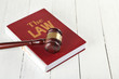 Gavel and book on wooden background