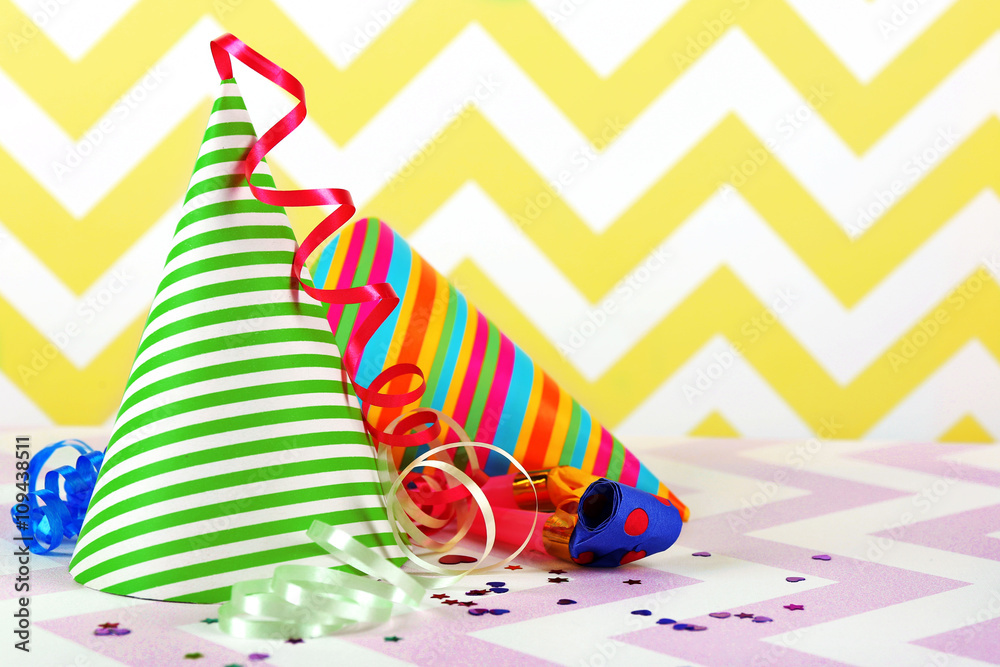 Party hats on a zigzag pattern background