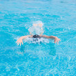 © mr.markin - Young girl in goggles and cap swimming butterfly stroke style in the blue water pool