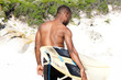 © mimagephotos - Young man with surfboard at beach