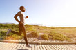 © mimagephotos - Fitness man running on the boardwalk at the beach
