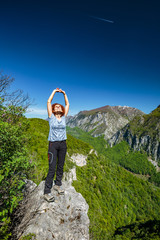 Happy lady on top of mountain