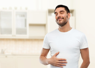 Poster - happy full man touching tummy over kitchen