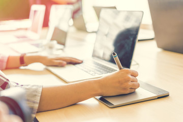 Leinwandbilder - Graphic designer using graphics tablet and computer laptop in th
