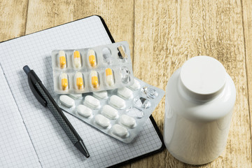 tablets on wooden desk with notebook and pen