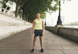 © Connect Images - Full length portrait of male runner holding water bottle