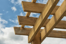 Closeup Shot At The Corner Of A Wooden Pergola Against Blue Sky