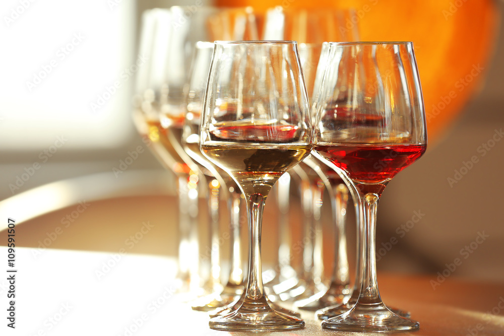 Many glasses of different wine on a table