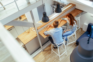 Couple sitting at counter in decorative home