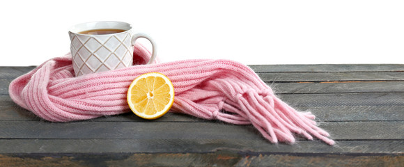 Fototapete - Beautiful winter composition with cup of hot drink, on wooden table with white background
