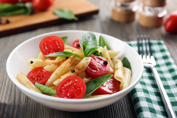 Sticker - Plate of pasta with cherry tomatoes and basil leaves on table closeup