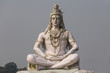 Hindu god Shiva sculpture sitting in meditation on Ganges river in Rishikesh, India, 2011