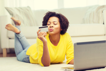 Canvas Print - happy african woman with laptop and credit card