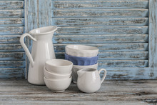 Vintage Crockery On A Light Wooden Background. Kitchen Still Life In Rustic Style