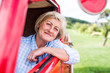© Halfpoint - Close up of senior woman inside vintage pickup truck
