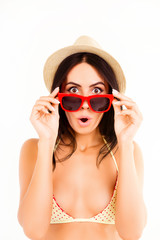 Wall Mural - Portrait of shocked pretty woman in bikini, hat and glasses