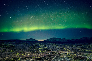 aurora borealis over distant mountains