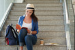 © DragonImages - Lovely female student sitting on steps and reading book