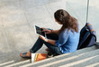 © DragonImages - Female student with tablet computer, view from above