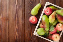 Pears And Apples In Wooden Box On Table