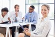 © WavebreakMediaMicro - Happy businesswoman using digital tablet in office