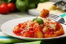 Serving Gnocchi In Tomato Sauce With Cheese.