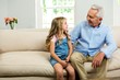 © WavebreakmediaMicro - Happy grandfather and girl sitting on sofa
