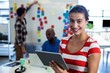 © WavebreakmediaMicro - Young woman holding digital tablet