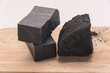 carbon soap  and a pile of coal on wooden tray