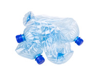 Mineral Water Bottles Crushed And Crumpled Against White Background