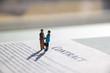 selective focus of miniature employees handshaking. Image of business contract.