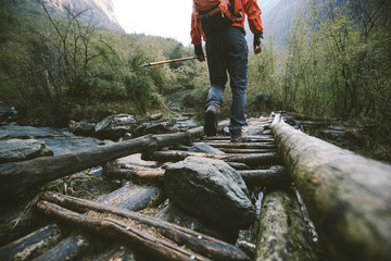 hiker crossing the bridge in himalayas