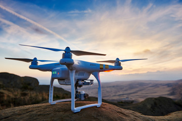 Wall Mural - drone quadrocopter with digital camera at sunset
