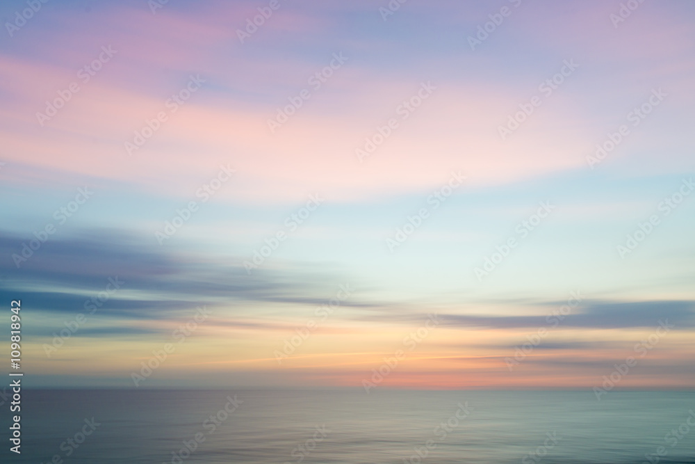 Blurred defocused sunset sky and ocean nature background. - obrazy, fototapety, plakaty 