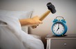 Man smashing alarm clock with sledge hammer