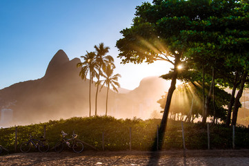 Fototapete - Sunset in Ipanema Beach with Palm Trees and Two Brothers Mountains