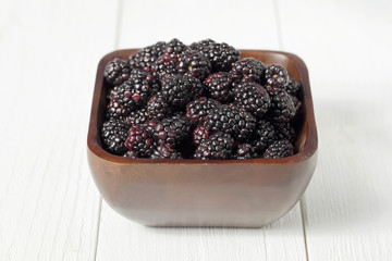 Canvas Print - pile of blackberries on wooden bowl