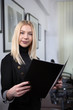 © dsneff - Friendly businesswoman holding a book