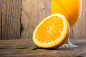 Wall Mural - Fresh orange juice with ice  on wooden background