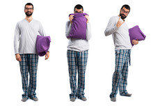 Man In Pajamas Hiding Behind His Pillow