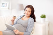 © Syda Productions - pregnant woman with tablet pc and credit card