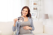 © Syda Productions - happy pregnant woman with ultrasound image at home