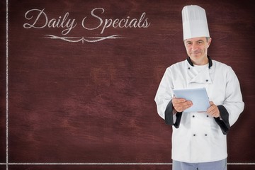 Poster - Composite image of chef standing holding a document