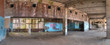 Panoramic view of the interior of abandoned dilapidated shopping center 