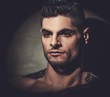 © Nejron Photo - Handsome hispanic man with naked torso posing on dark background.